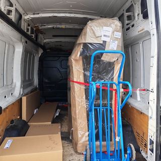 Wrapped fridge on a trolley in the van